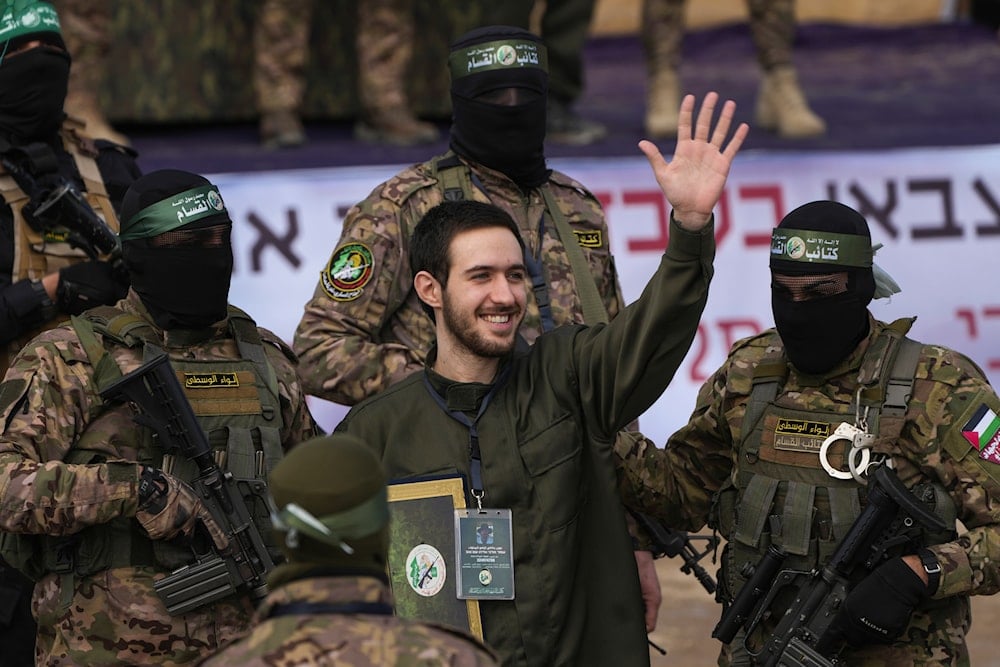 Israeli hostage Omer Shem Tov, centre, is escorted by Hamas fighters before being handed over to the Red Cross in Nuseirat, central Gaza Strip, Saturday, Feb. 22, 2025 (AP)