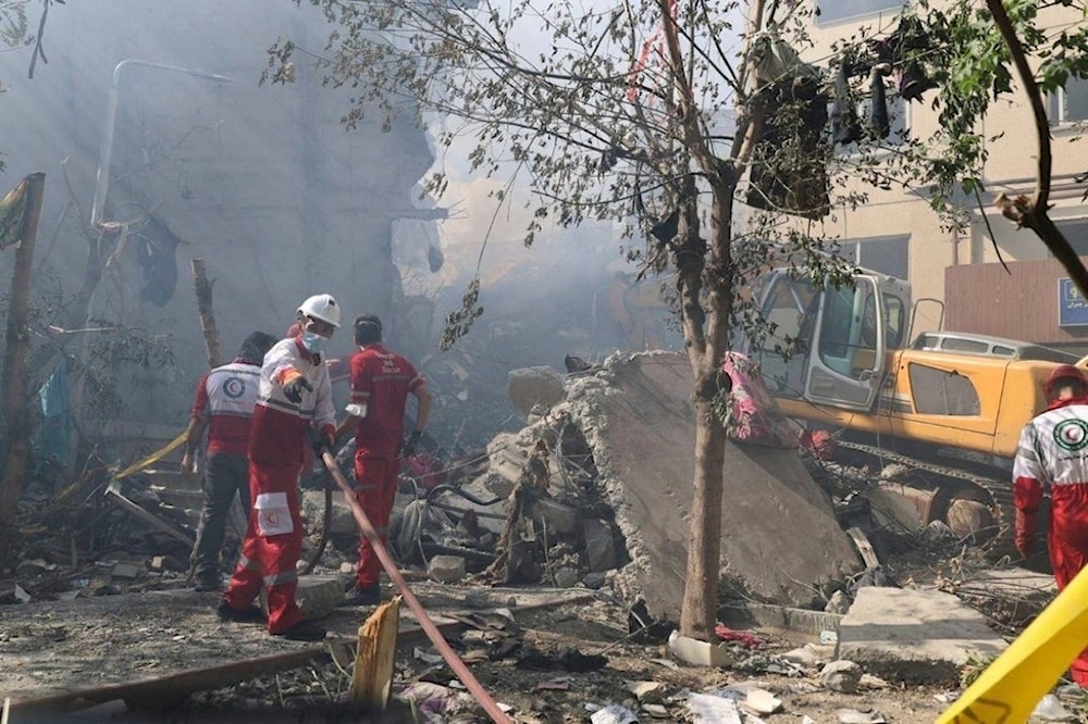In this photo released by the Iranian Red Crescent Society rescuers work at the scene of an explosion after an Israeli strike in Tehran, Iran, Friday, June 13, 2025. (AP)